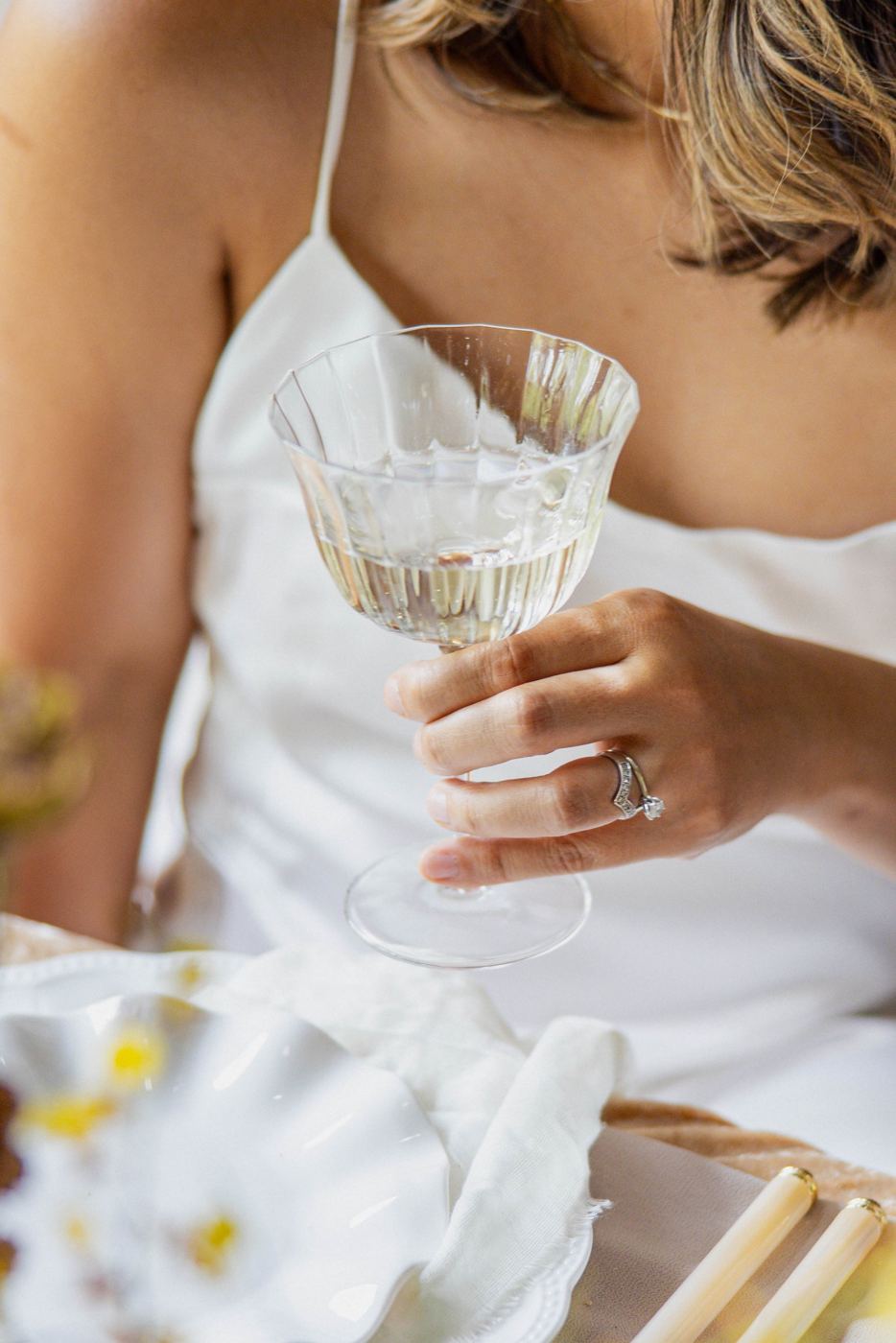 Guest holding a ribbed crystal coupe